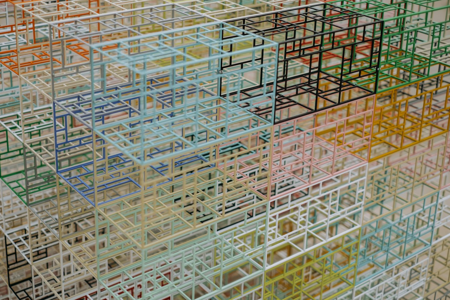 Colorful wireframe cubes and prisms form a complex network.